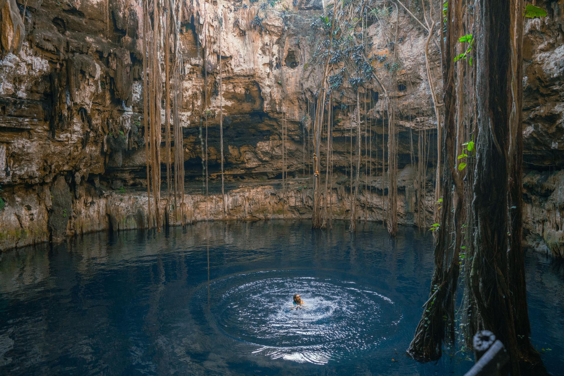 Man swimming  in Cenote in Yucatan, Mexico