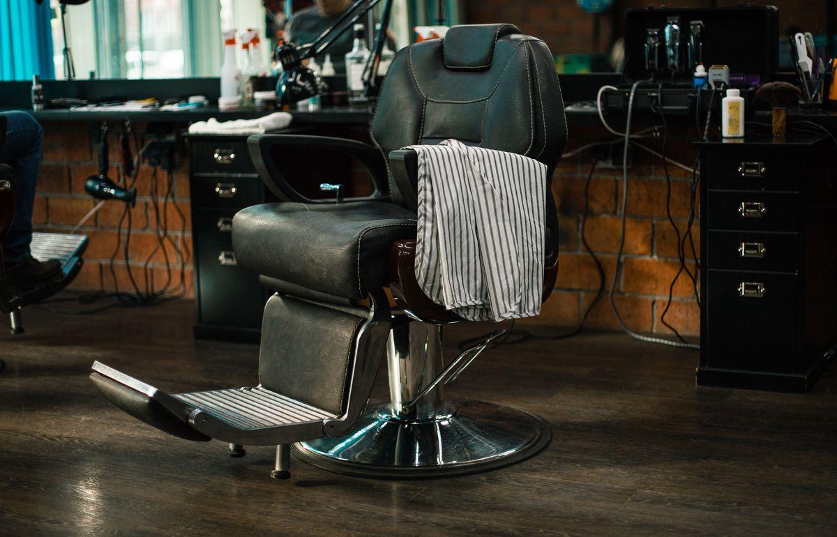 Hairdressing armchair. a modern hair salon for men. Workshop of hairdressers. Beauty salon with chairs, hair dryers, combs and mirrors. Barbershop armchair.