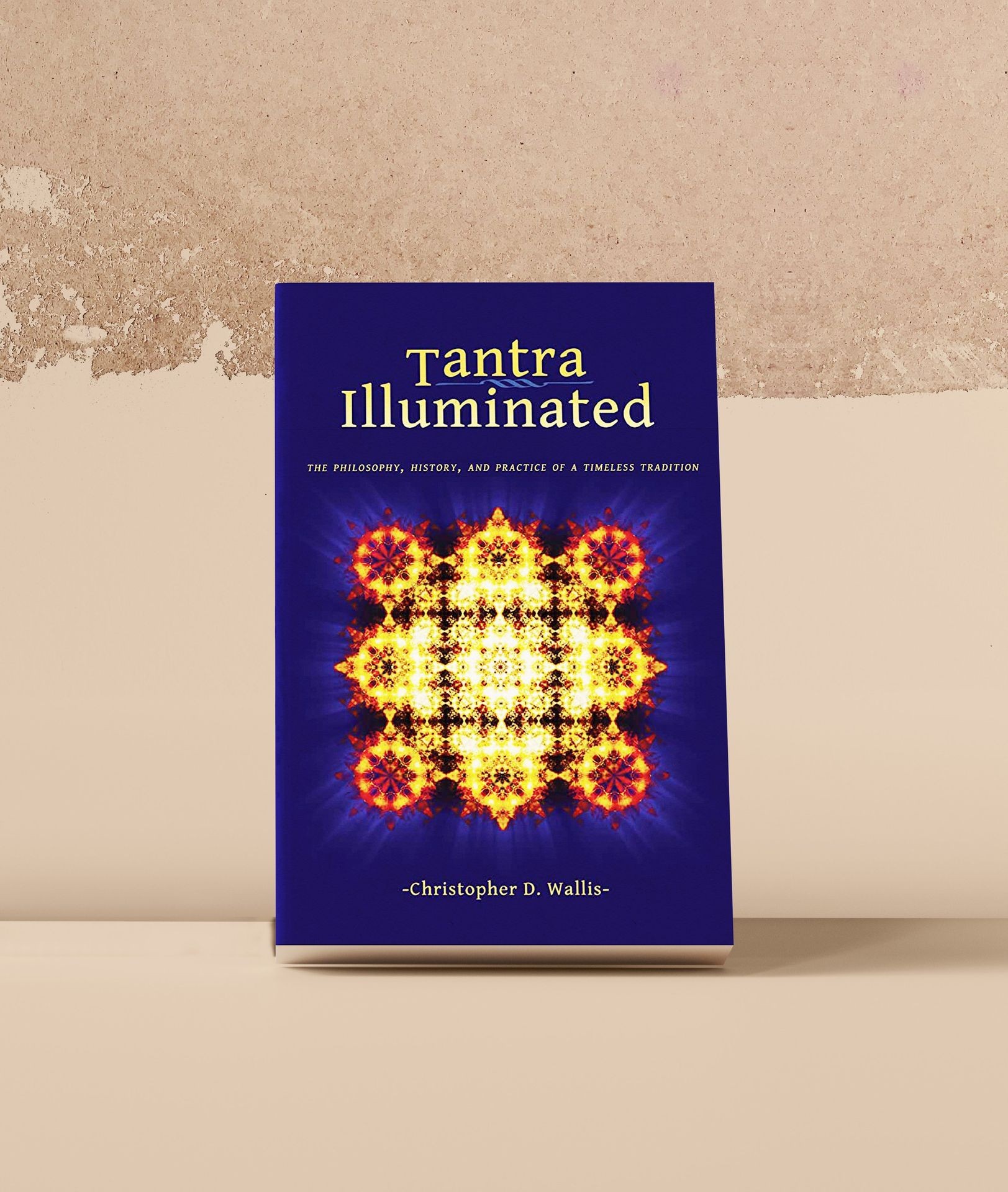 Book cover titled 'Tantra Illuminated' with colorful symmetrical design on a purple background.